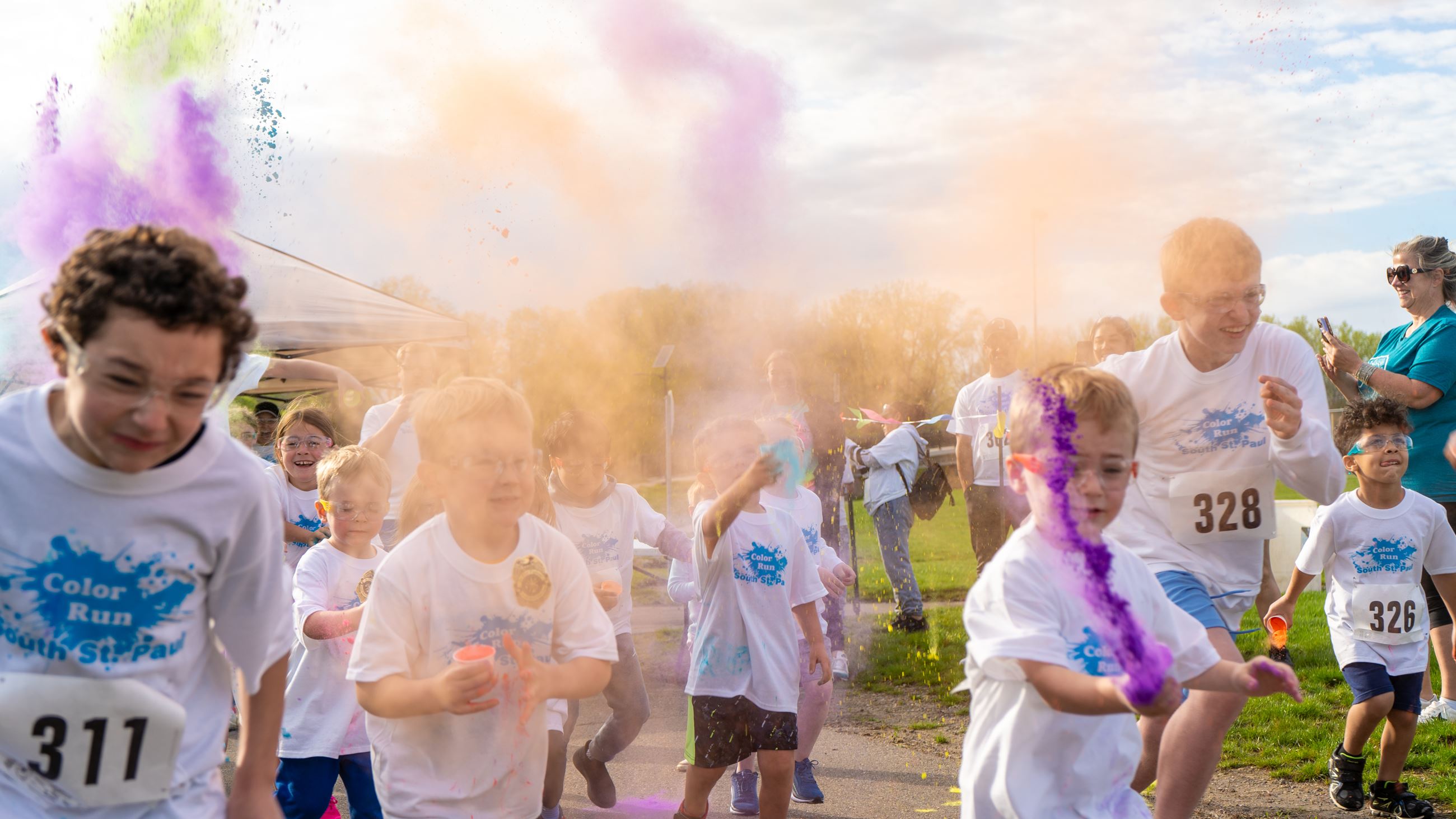 A group of runner as the color run began - colored powder thrown in the air