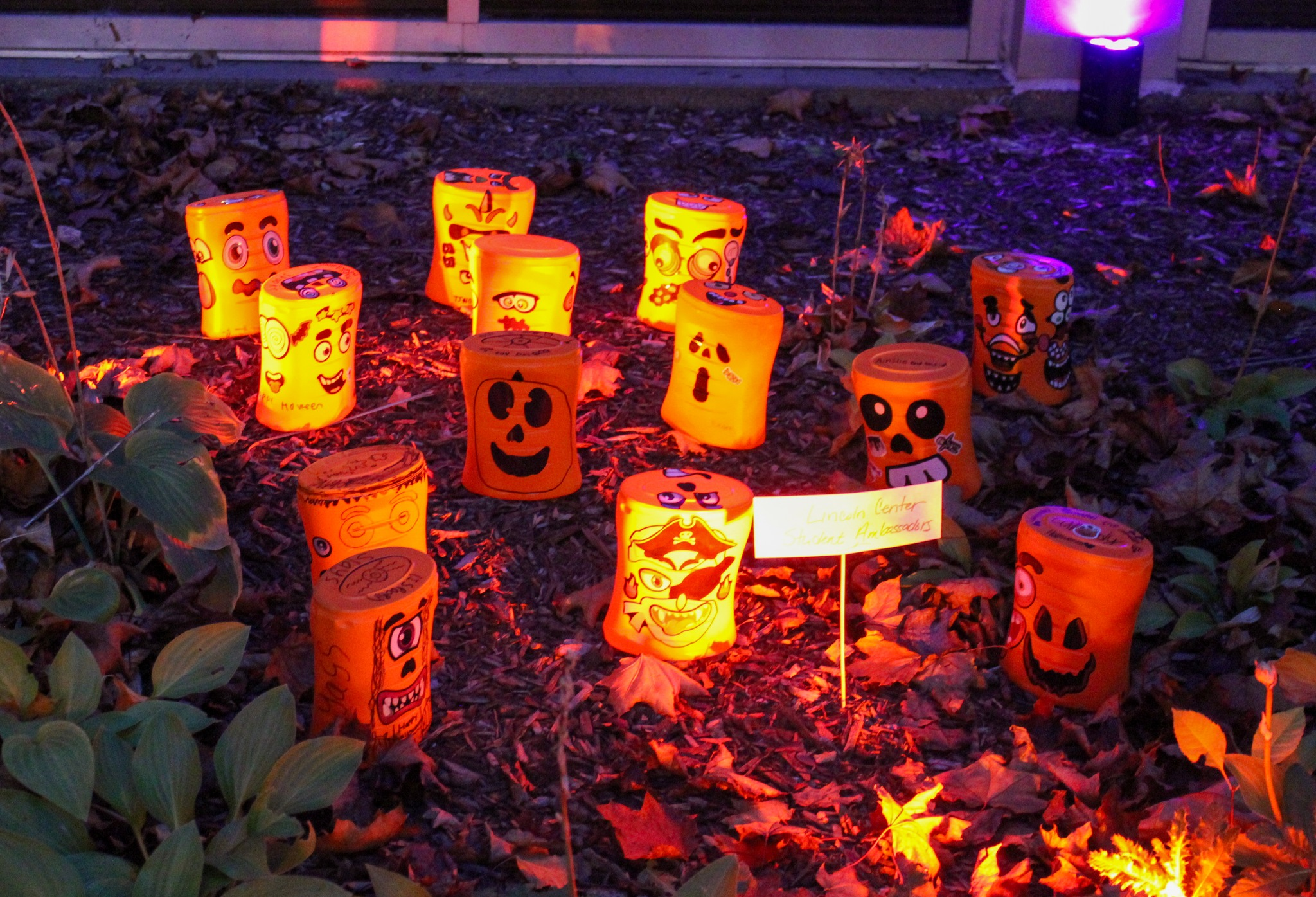 Up-cycled laundry soap containers decorated as pumpkins
